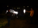 FZ024584 Jenni and Phill setting of sparklers in the garden.jpg